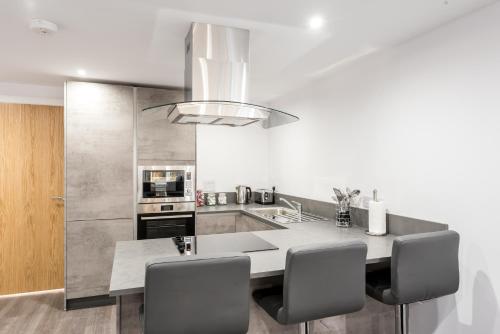 a kitchen with a table and some chairs in it at Casa Fresa - Castlehill Apartment in Dundee