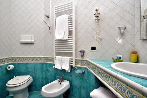 a bathroom with a toilet and a sink at Hotel La Tonnarella in Sorrento