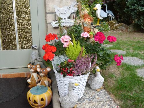 a bunch of stuffed animals sitting next to a basket of flowers at Ferienhaus Cramer in Walkenried