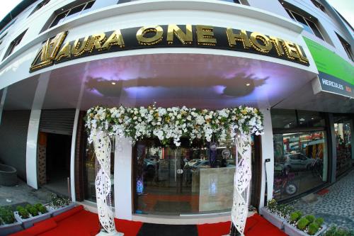 a revolving entrance to a restaurant with flowers at Aura One Hotel in Cochin