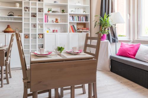 a dining room table with two chairs and a table and chairsktop at B&B Alegría in Mechelen