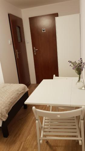 a room with a table and a chair and a door at Pokoje gościnne Venezia in Czaplinek