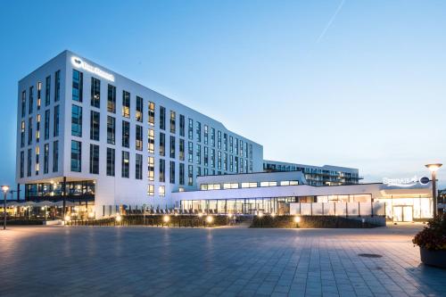 a large white building with lights in front of it at aja Travemünde in Travemünde