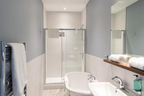 a bathroom with a shower and a toilet and a sink at The View Hotel Folkestone, a member of Radisson Individuals in Folkestone
