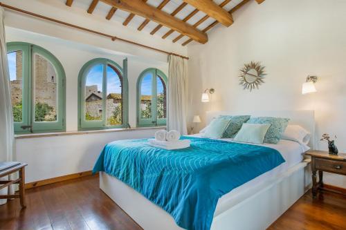 ペラタリャーダにあるFlateli Peratalladaのベッドルーム1室(青いシーツと窓付)