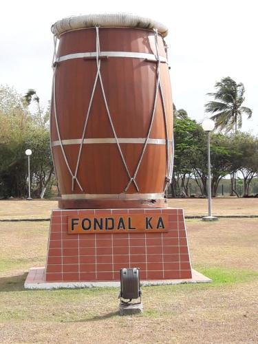 a large barrel sitting on top of a sign at Méline in Baie-Mahault