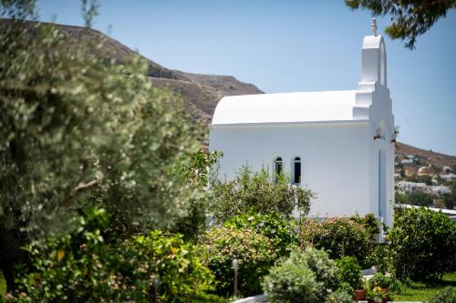 a white church with a cross on the side of it at Pyrgaki Hotel in Parikia
