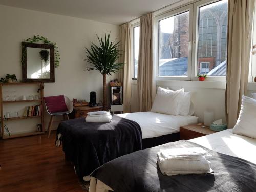 a hotel room with two beds and a window at City Break Amsterdam in Amsterdam