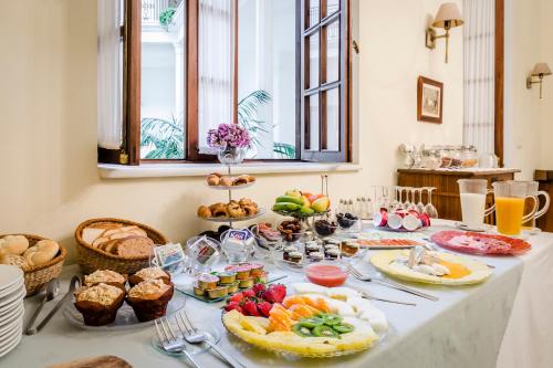 a table with breakfast foods and drinks on it at Hotel YIT Casa Grande in Jerez de la Frontera