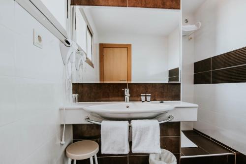 a bathroom with a sink and a mirror at Hotel Isasa in Logroño