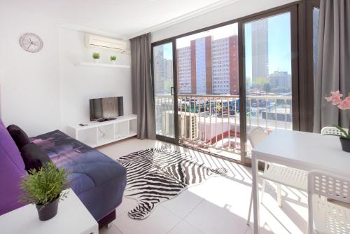 a living room with a view of a city at My Pretty Payma Apartamentos in Benidorm
