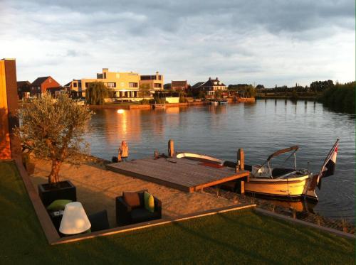 a boat is docked at a dock on a lake at WK12 Suite in Cuijk