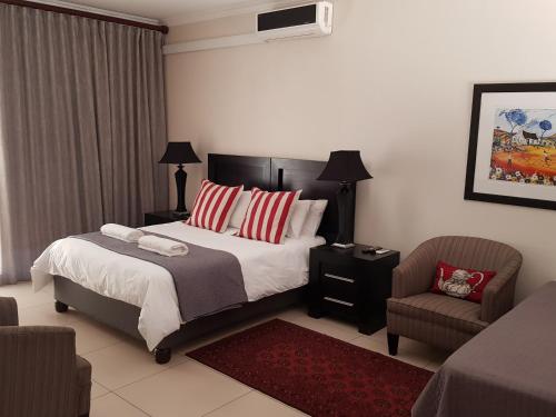 Ένα ή περισσότερα κρεβάτια σε δωμάτιο στο Presidensie Guest Rooms