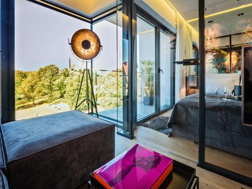 a bedroom with a bed and a large window at Andersia Park in Poznań