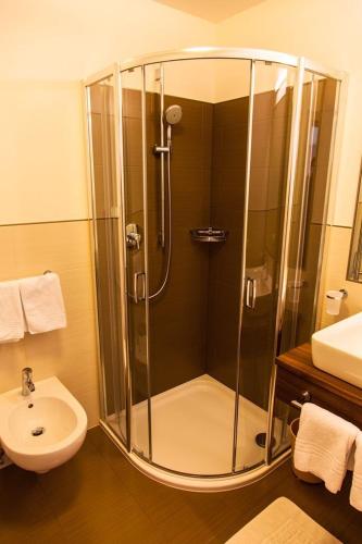 a bathroom with a shower and a sink at Residence Armonia in Colfosco