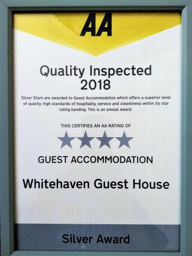 a sign for a guest accommodation at a silver guest house at Whitehaven Guest House in Whitby