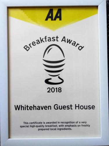 a sign for a wirelesshaven guest house with a microphone at Whitehaven Guest House in Whitby