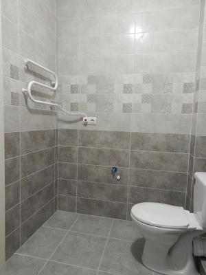 a bathroom with a toilet and a shower at Ukrainska Apartment in Irpin