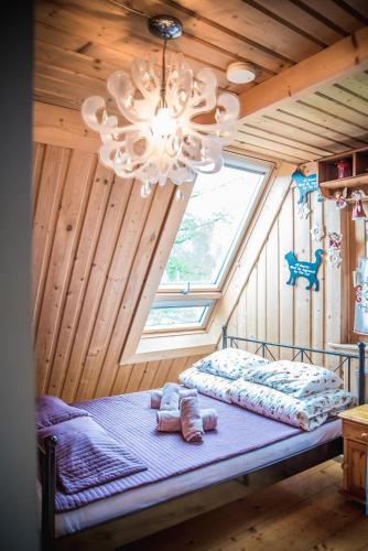 a bedroom with a bed in a room with a chandelier at Rezydencja Sąsiadów Zakopanego in Zakopane