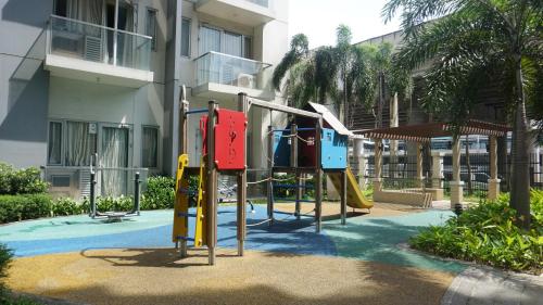 a playground in front of a building at Palm Tree Condos across NAIA3 by Beth in Manila