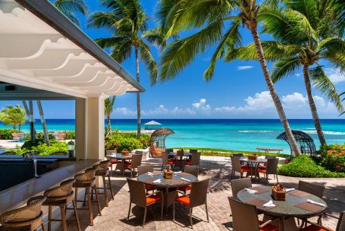 a patio area with tables, chairs and umbrellas at Jewel Grande Montego Bay Resort and Spa in Montego Bay