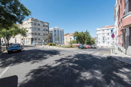 a city street with cars parked on the street at Safe House in Lisbon