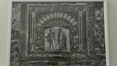 a picture of a painting of two men on a wall at Villa Cua in Ercolano