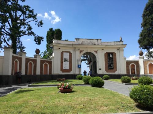 a building with an arch in a park at Villa Cua in Ercolano