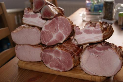 a pile of meat on a cutting board on a table at U Jasia - Agroturystyka in Bańska Niżna
