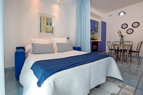a blue and white bedroom with a large bed at Angelina Residence in Maiori