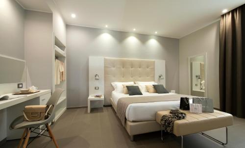 a bedroom with a large bed and a desk at Hotel H21 in Milan