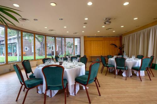 a conference room with tables and chairs and windows at The Royal Foundation of St Katharine in London