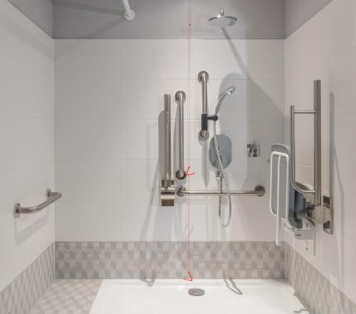 a bathroom with a shower with a glass door at Eden Locke in Edinburgh