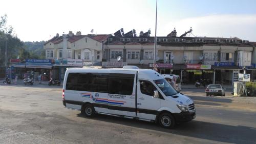 a white van is parked on a street at Oludeniz Hostel in Fethiye