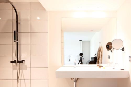 a bathroom with a sink and a mirror at Auberge Du Paradis in Saint-Amour-Bellevue
