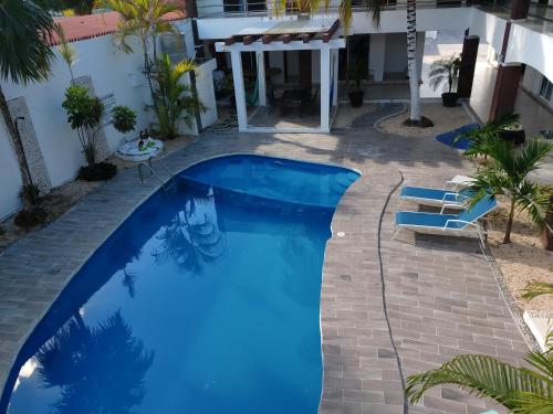 a swimming pool in the backyard of a house at Hotel España in Chetumal