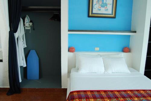 En eller flere senger på et rom på Hotel Villas Las Anclas