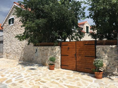 a wooden gate in front of a house at Holiday Home Cvita in Lozovac