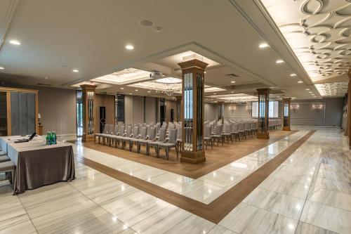 a banquet hall with a table and chairs in a room at Hotel Traugutta3 in Białystok