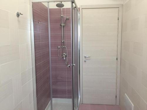a shower with a glass door in a bathroom at Diamante in Sorrento