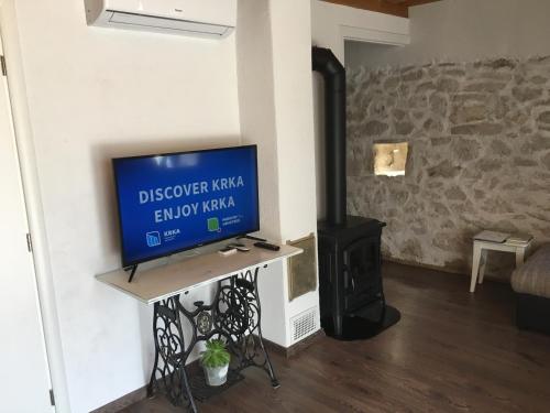 a living room with a tv and a stove at Holiday Home Cvita in Lozovac
