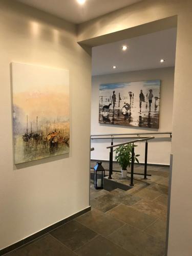 a hallway with two paintings on the wall at Weinbergs Loge in Ernst