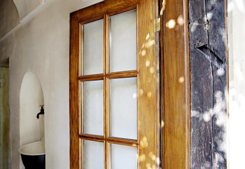 a wooden door with glass windows in a room at Aparthotel Karmel in Kraków
