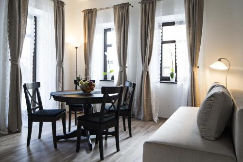 a living room with a table and chairs and a couch at Vila Mila in Bled