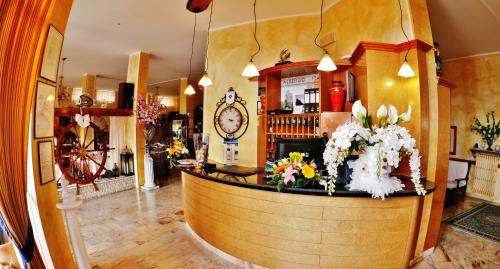 a bar in a restaurant with a clock on the wall at Hotel Italia in Lerici