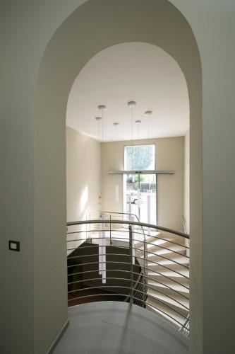 a hallway with a spiral staircase in a house at Hotel H21 in Milan
