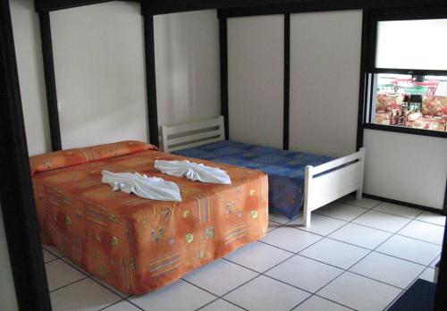 מיטה או מיטות בחדר ב-Pousada Morada Das Toninhas