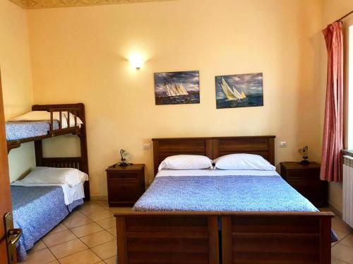 a bedroom with two beds and a bunk bed at Agriturismo Il Poderino in Tarquinia