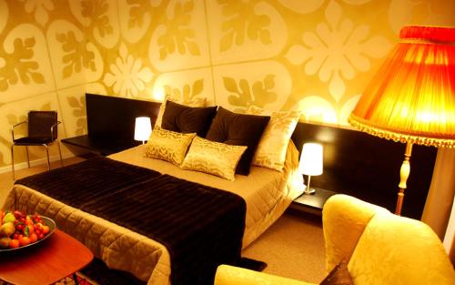 a bedroom with a bed and a table with a lamp at Avogaria 5 Rooms in Venice