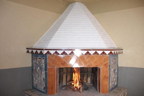 a large brick fireplace with a white roof at Dar Imperial in Imlil